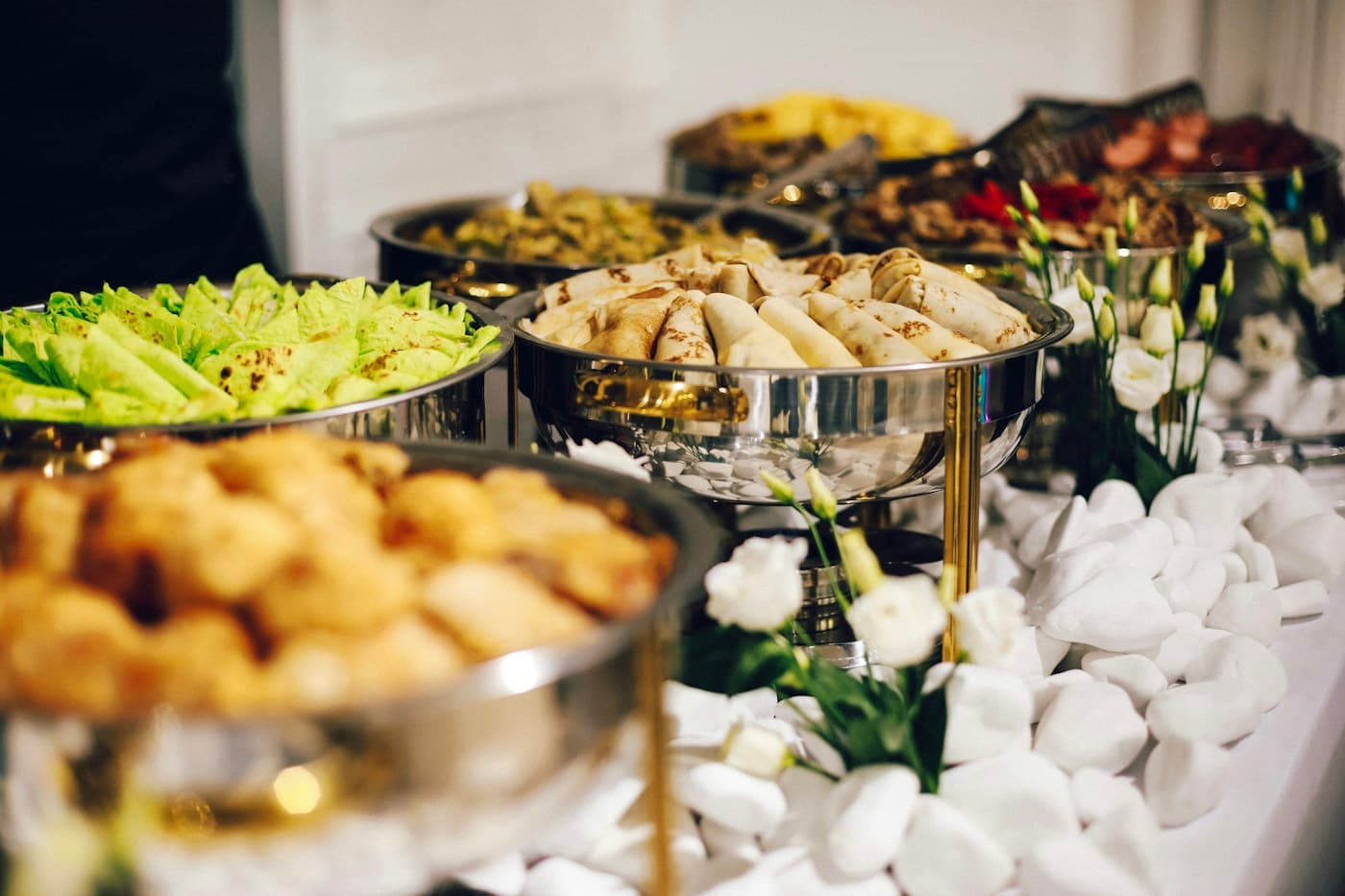Prepared dishes and serving utensils arranged for professional buffet catering