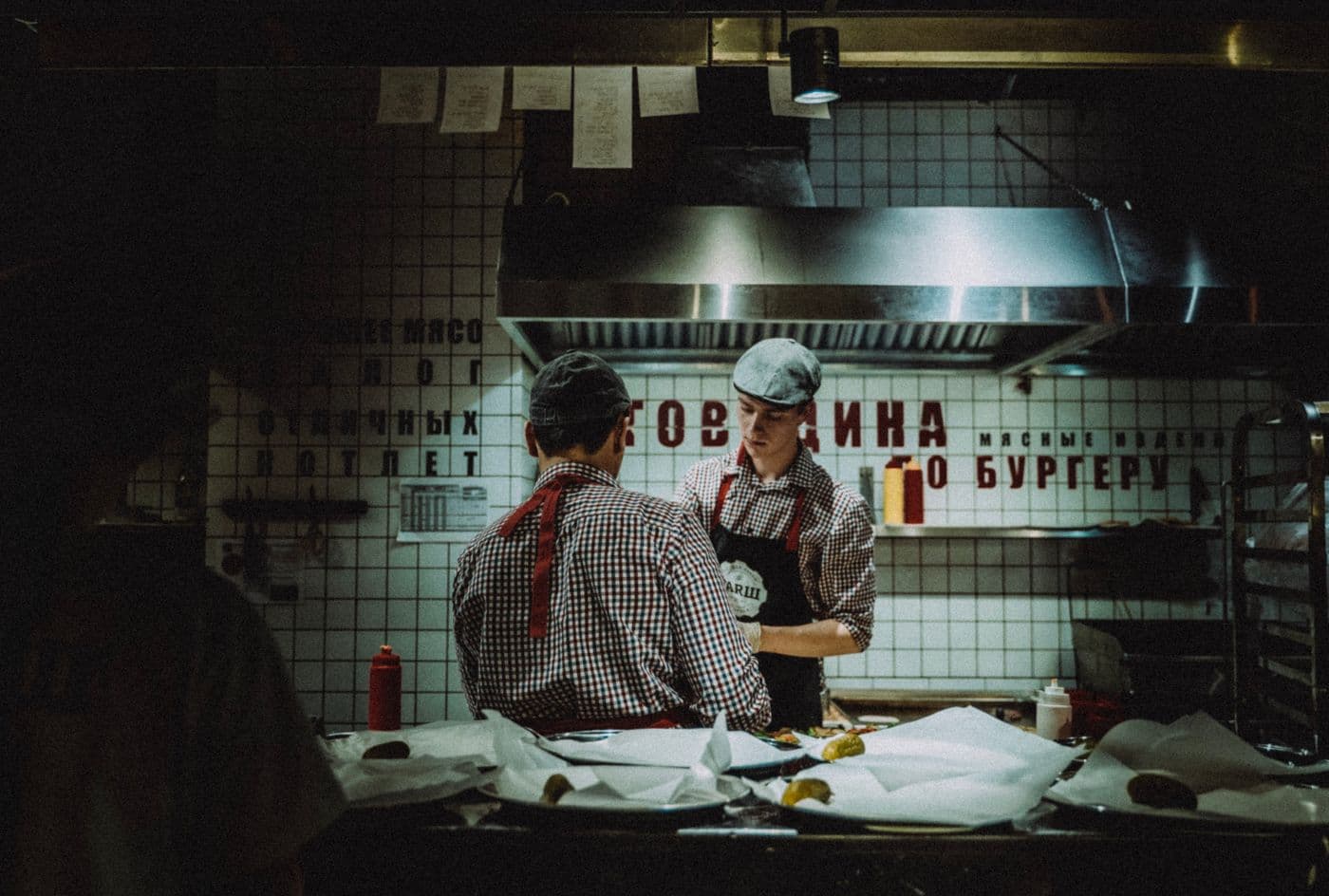 A commercial kitchen team preparing food for service